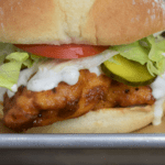 Buffalo Chicken Sandwich with blue cheese dressing, lettuce, tomato and pickles.