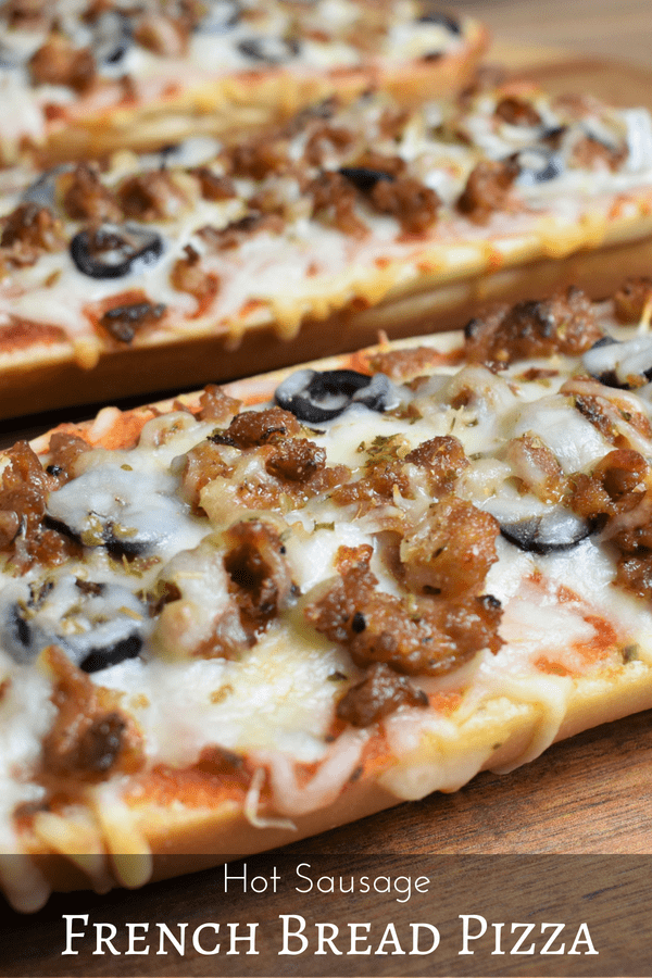 This hot sausage French bread pizza is an easy and delicious dinner for busy weeknights, movie night or game-day. French bread is topped with olive oil, marinara sauce, mozzarella cheese, hot Italian sausage, sliced onions and black olives. #frenchbreadpizza #hotitaliansausage #hotsausage #homemadepizza #gamedayfood #easydinner #pizza