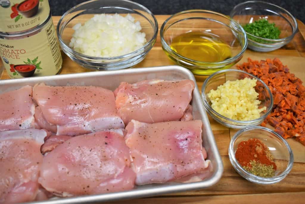 The ingredients for pollo en salsa recipe displayed on a cutting board.