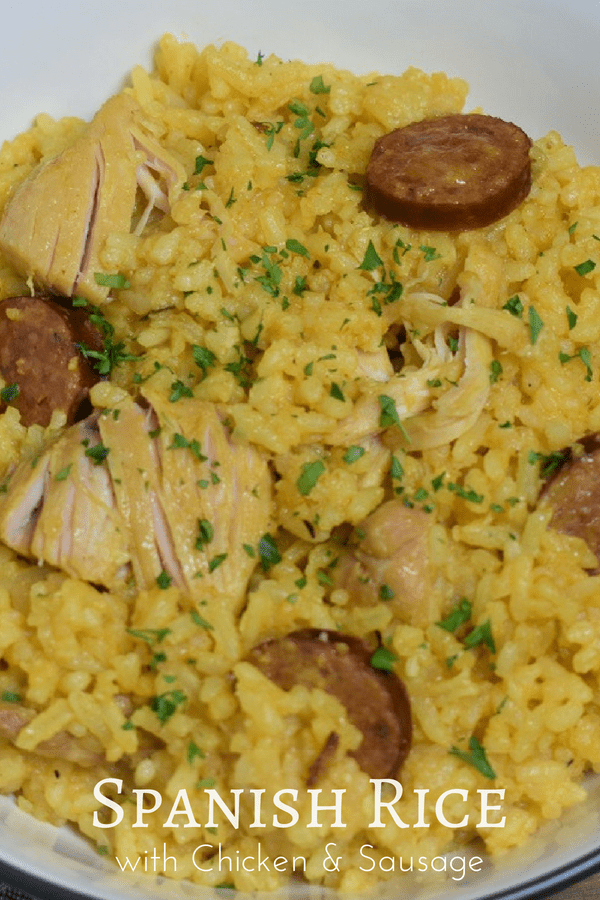 This Spanish rice with chicken and sausage is a stick-to-your-ribs kind of dinner. It’s not fancy but it sure is good. Chicken thighs and andouille sausage are cooked with onions, lots of garlic and a combination of spices. The rice is cooked in the same pot, we even add a beer, arroz con pollo-style, to help steam the rice. #spanishrice #rice #ricechickensausage #yellowrice #chickenandrice #cook2eatwell