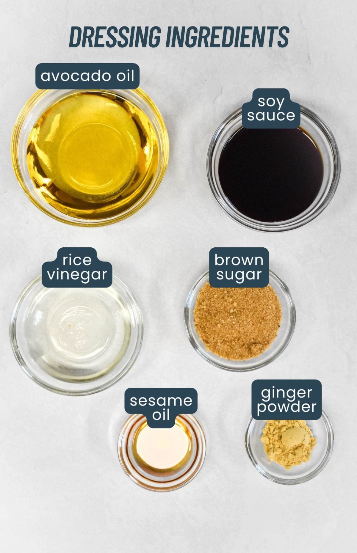 Small bowls of labeled ingredients for sesame dressing, including avocado oil, soy sauce, and rice vinegar.