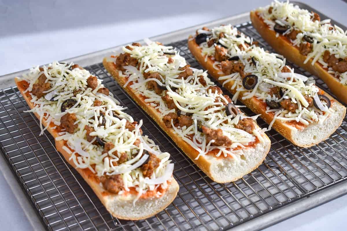 An image of the four slices, before baking, set on a baking sheet lined with a cooling rack.