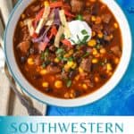 A close up of the finished southwestern steak soup garnished with tortilla strips, sour cream, and chopped parsley with a teal and white graphic underneath with the title in teal letters.