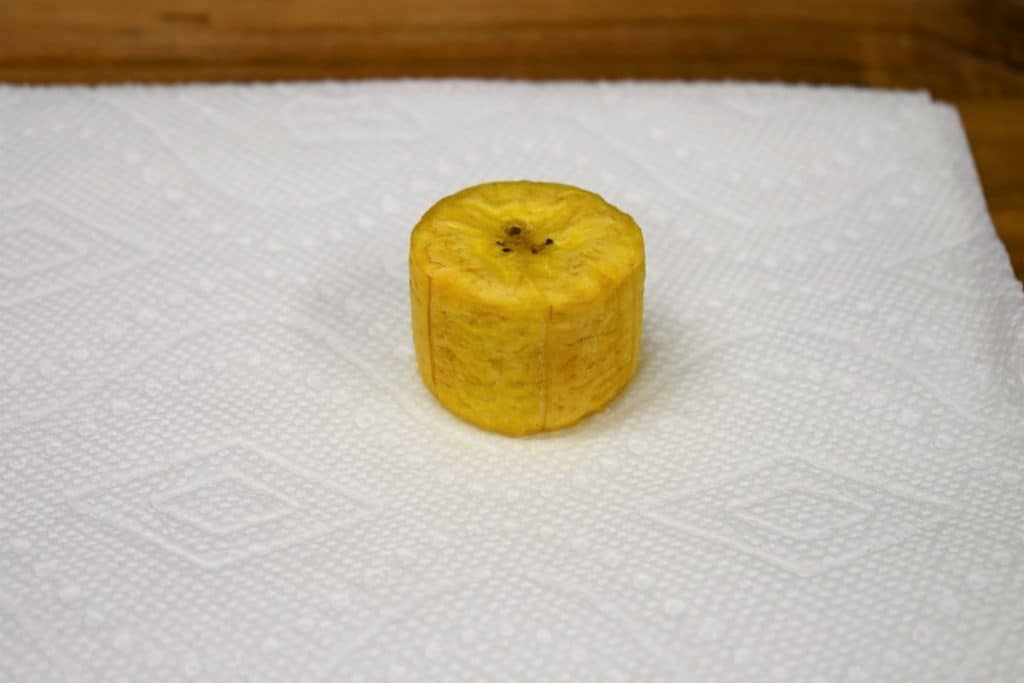 Tostones one fried green plantain round on a paper towel