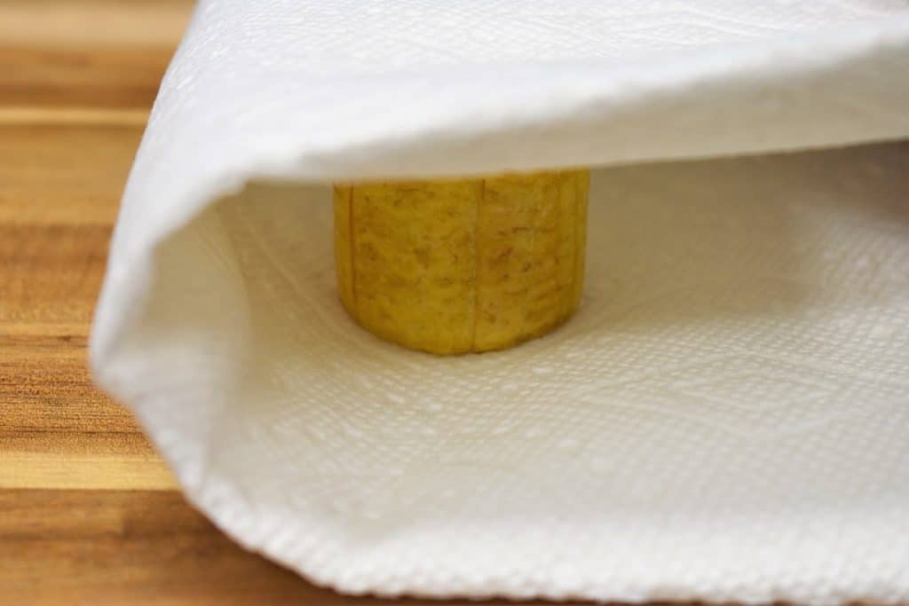 Tostones Green Plantain Ready to Be Flattened using a paper towel