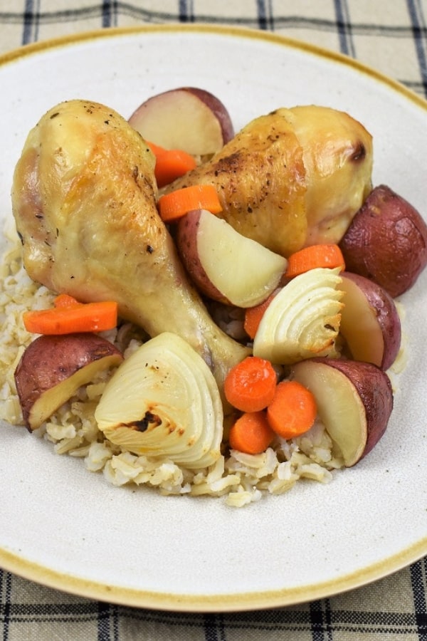 This baked chicken and vegetables is a whole meal in one pan. This dish is really easy to prep and cook. While the cooking time is a little over an hour, it’s totally hands off. Once it’s done, you’ll have a wholesome, filling and delicious meal with very little fuss. If you need to stretch a serving, serve the baked chicken and vegetables with brown rice, they’re perfect together. #bakedchickenandvegetables #bakedchicken #onepotchickenrecipes #onepotmeals #chickenrecipes