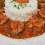 Camarones Enchilados served with white rice in a white plate.