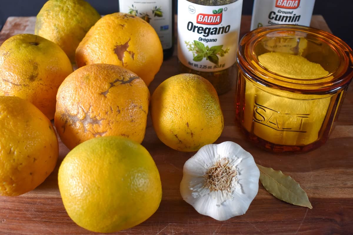 The ingredients for mojo displayed on a wood cutting board.