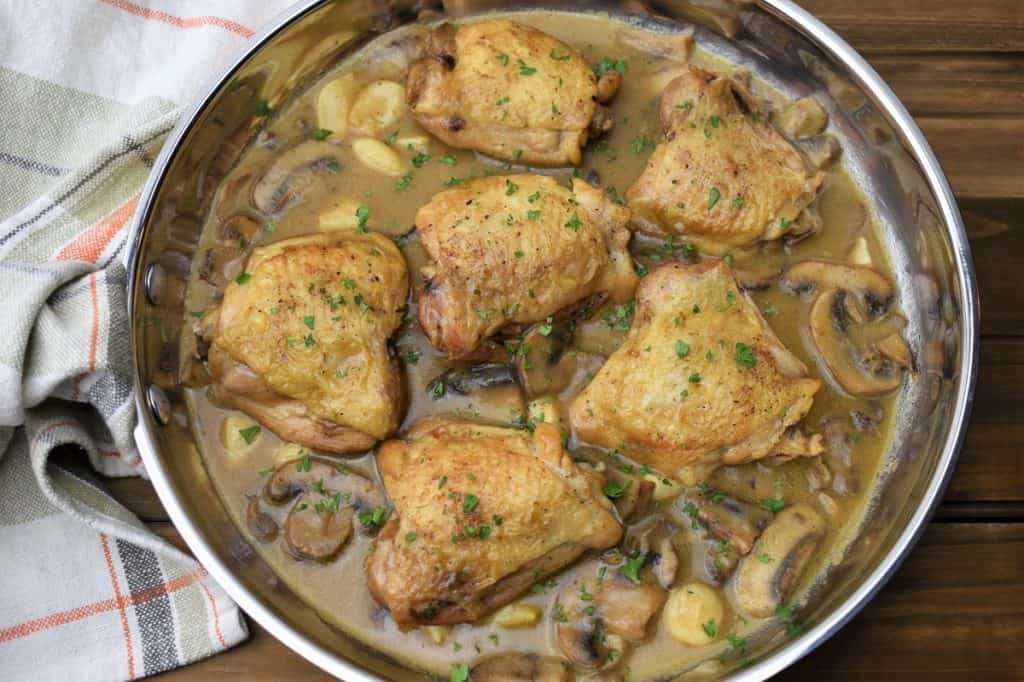 Braised Chicken Thighs with mushroom garlic sauce in a large skillet
