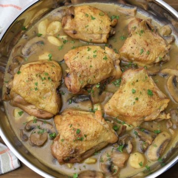 Braised Chicken Thighs with mushroom garlic sauce in a large skillet