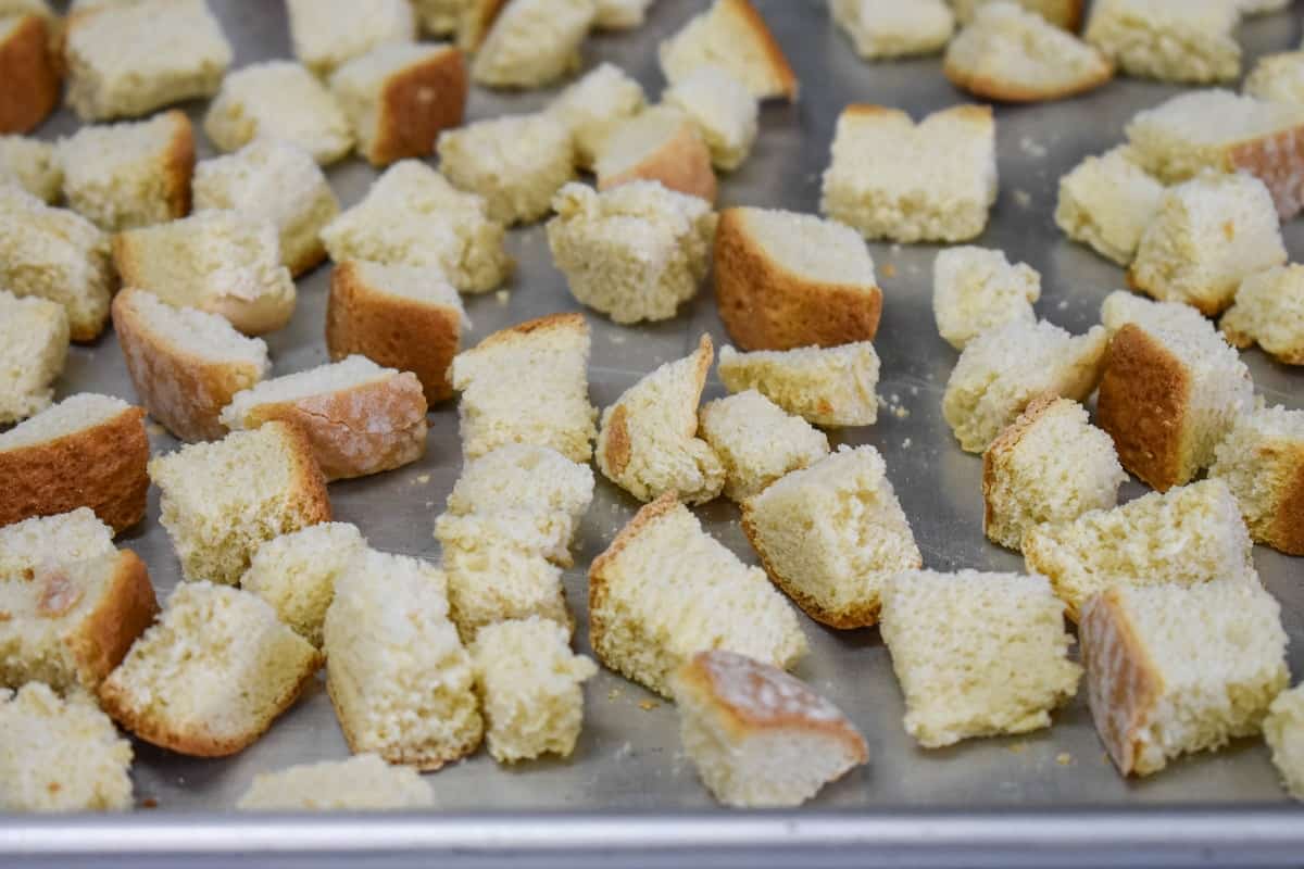 Homemade croutons on a baking sheet.