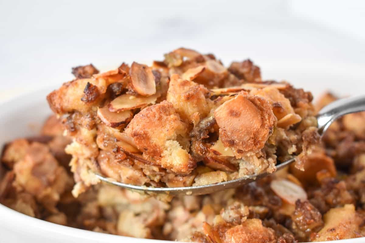 A close up of a serving spoon holding up a serving of the finished stuffing.