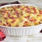 Baked ham and cheese pasta in a large white casserole dish