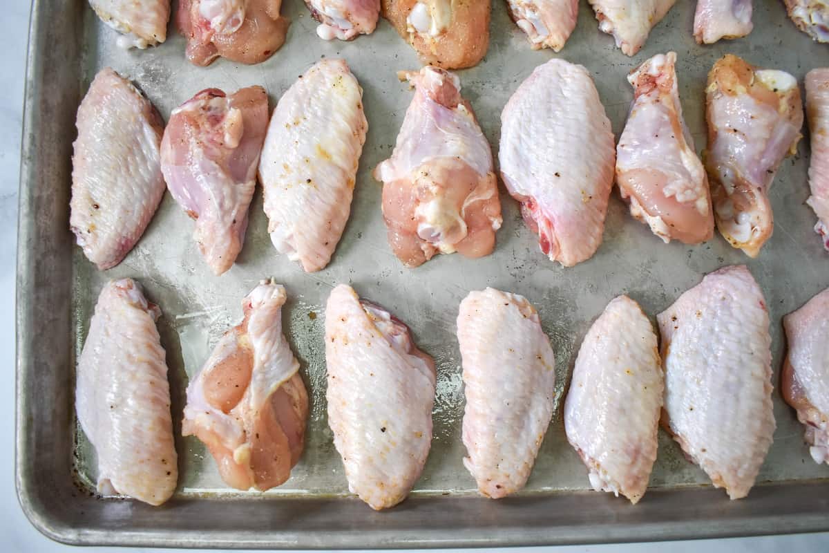 The chicken arranged on a large baking sheet.