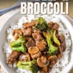 Bowl of beef and broccoli with mushrooms served over white rice, topped with bold text that reads “Beef & Broccoli.”