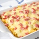 The finished ham and cheese casserole displayed on a table with a blue and white linen in the background.