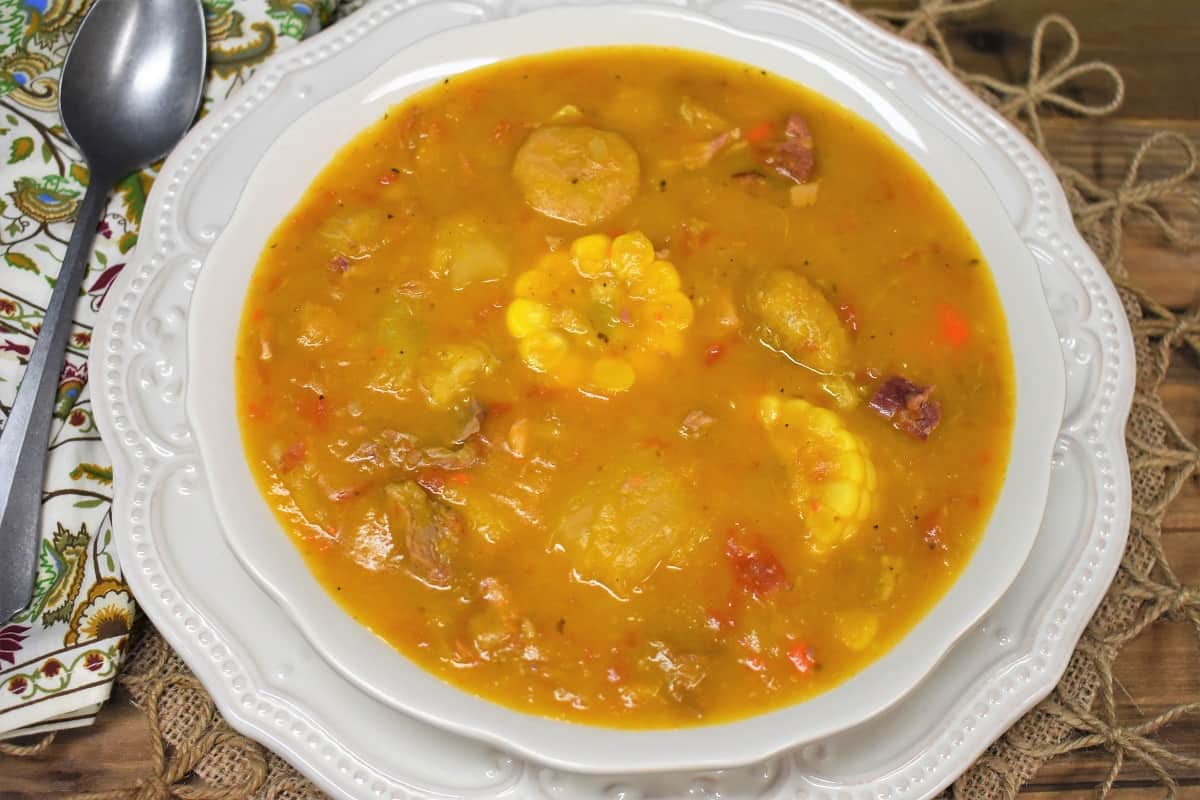 Ajiaco soup served in a large white, shallow bowl