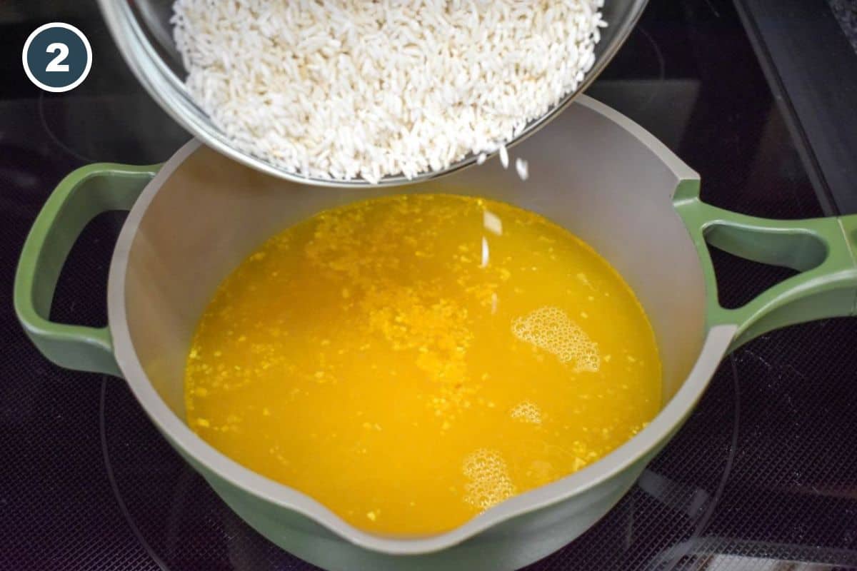 Long-grain white rice being added to the seasoned cooking liquid.
