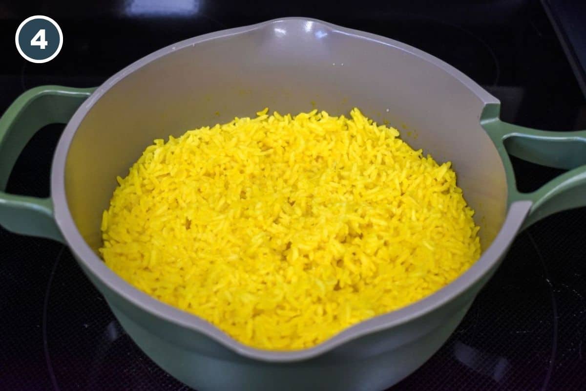 Cooked rice uncovered in the saucepan after simmering.