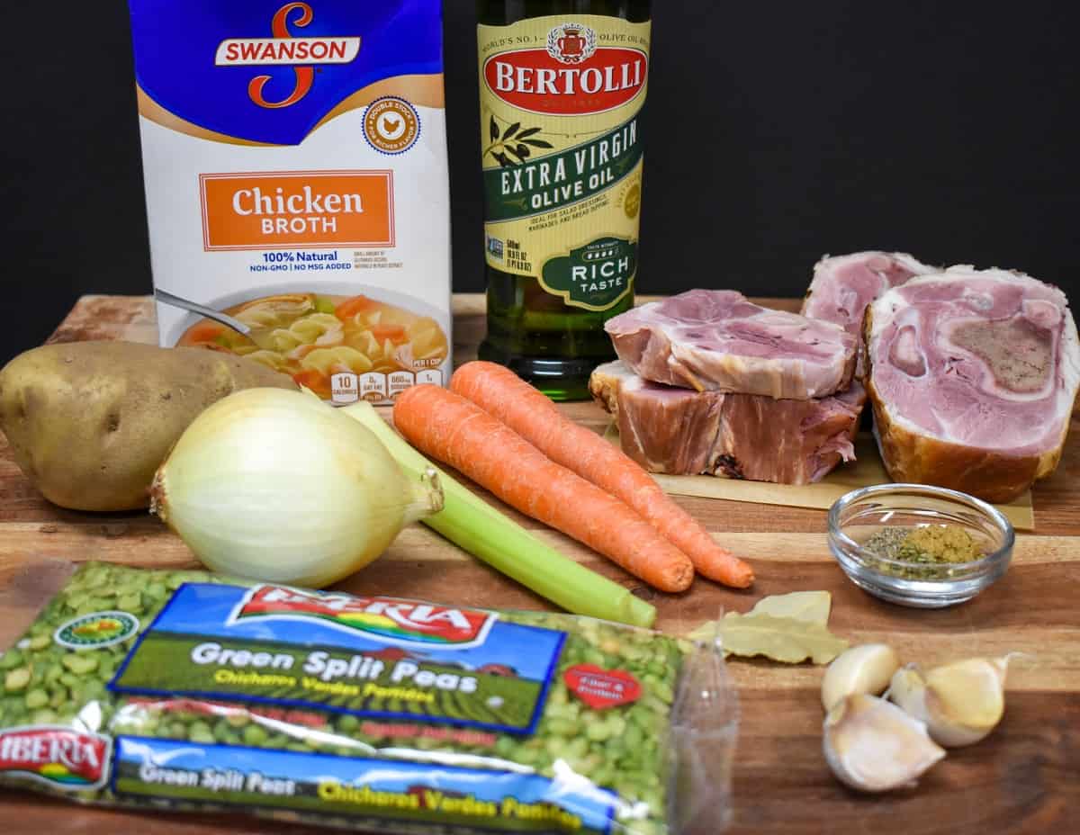 The ingredients for the split pea soup displayed on a wood cutting board.