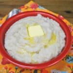 Puré de Malanga with a pat of melting butter, served in a red bowl.