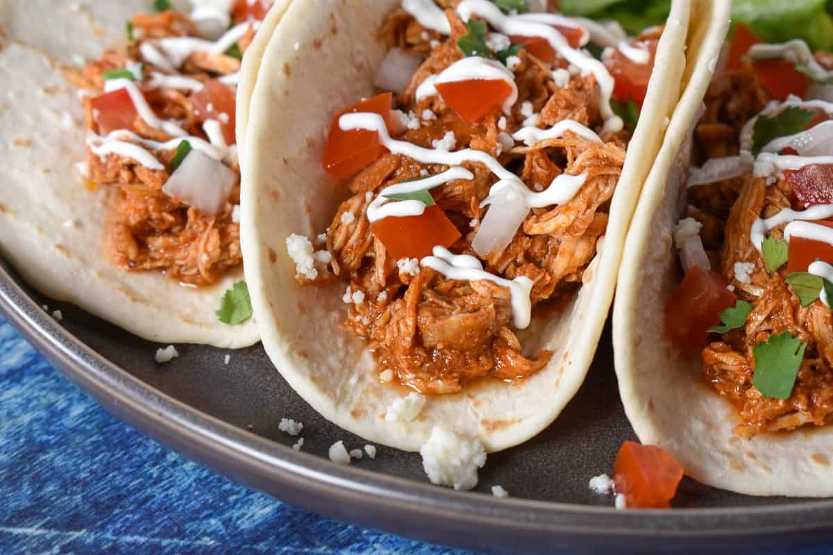 Shredded chicken served in flour tortillas and topped with diced tomatoes, onions, sour cream and cilantro.