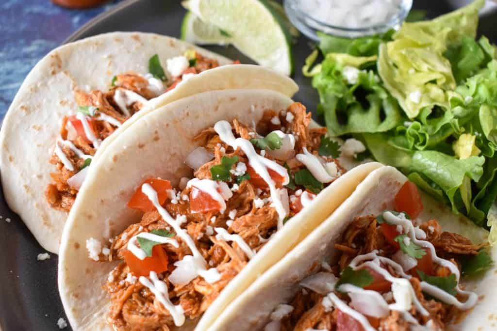 Shredded chicken served in flour tortillas topped with sour cream, diced tomatoes, onions and cilantro.