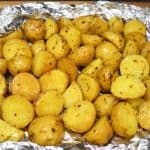 Grilled small gold potatoes in an open foil pack