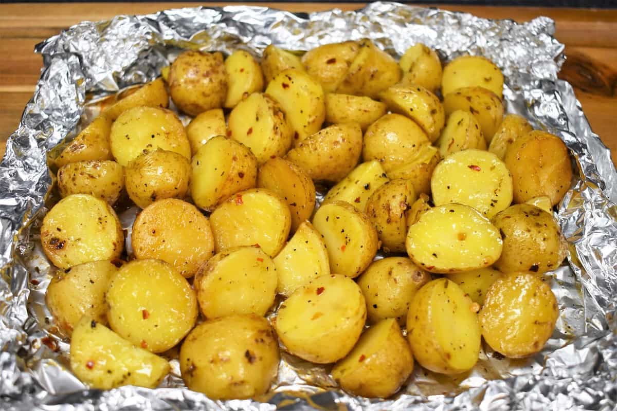 Grilled small gold potatoes in an open foil pack