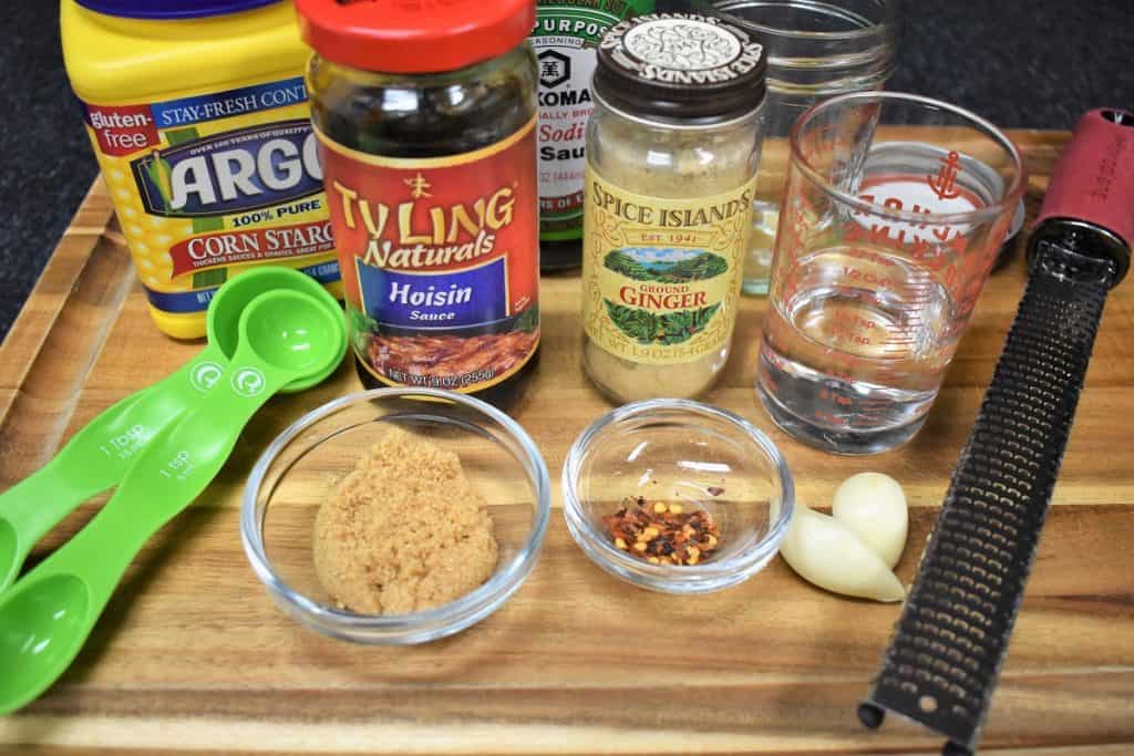 Stir fry sauce ingredients arranged on a wood cutting board.
