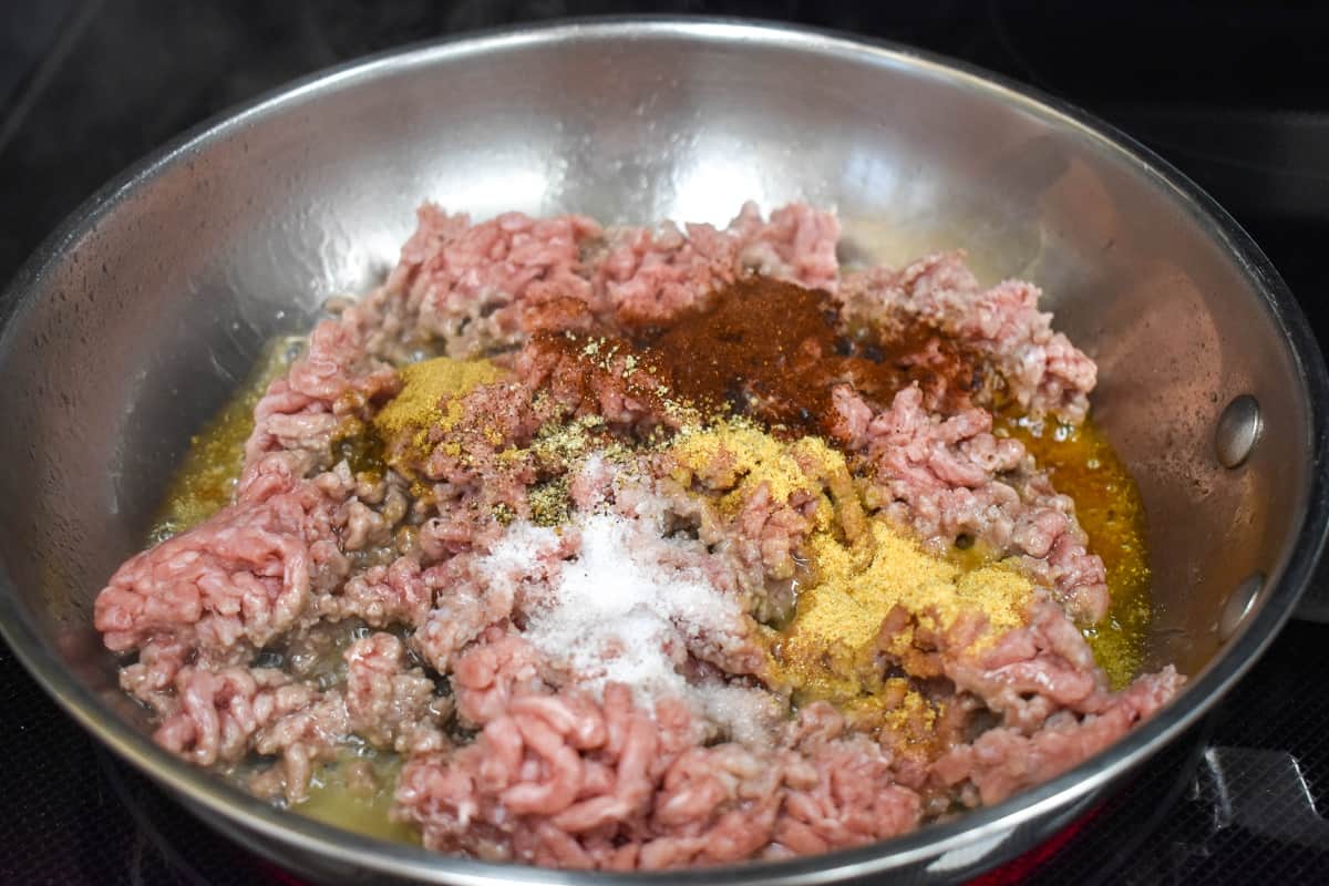 Ground beef and spices in a skillet.