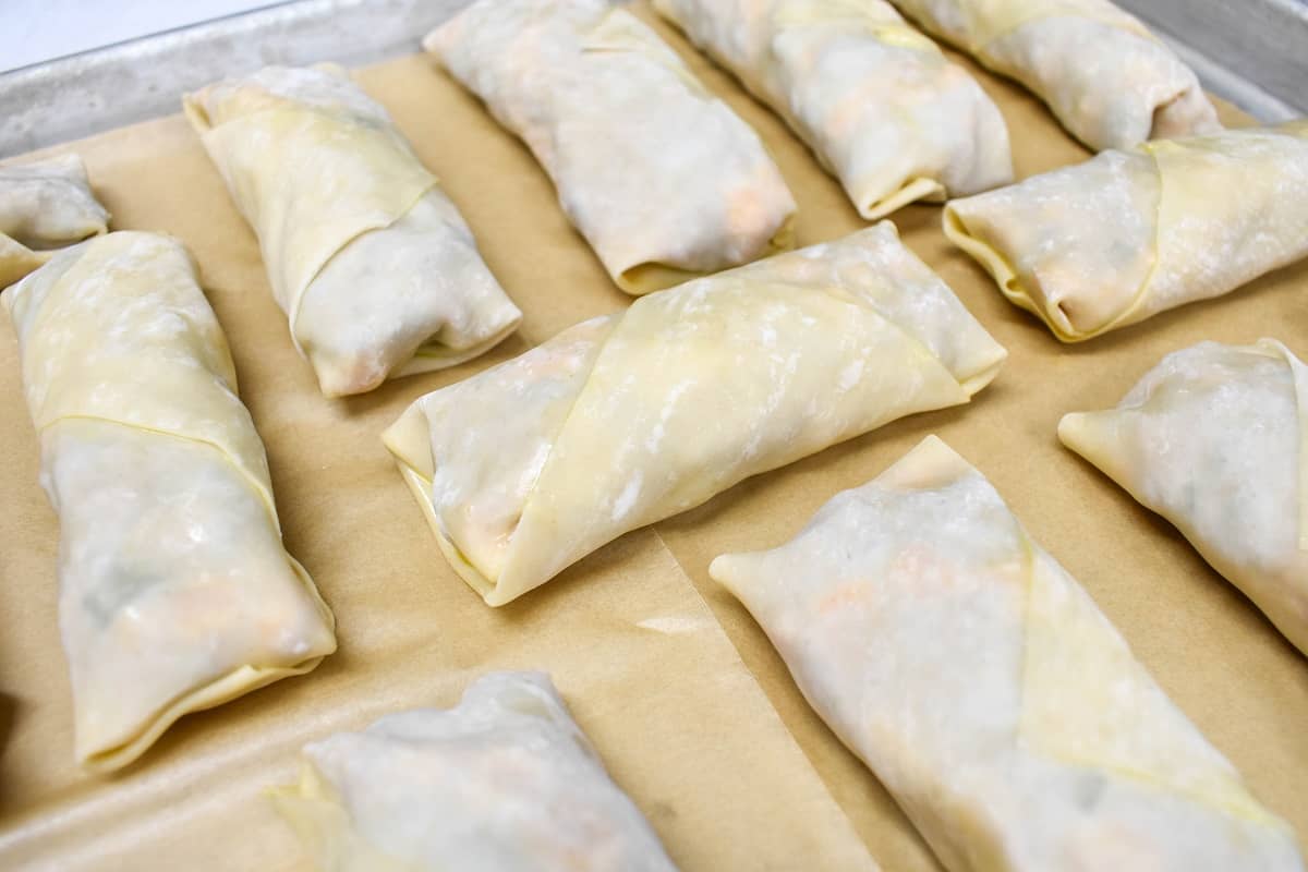 The southwestern egg rolls set on a sheet pan lined with parchment paper.