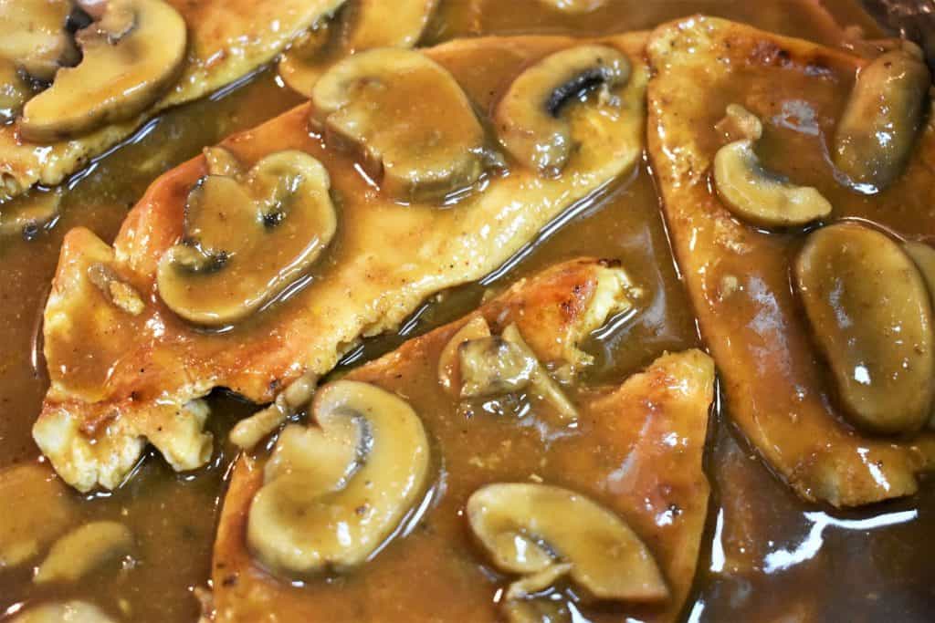 Thin chicken breasts in a deep brown mushroom sauce.