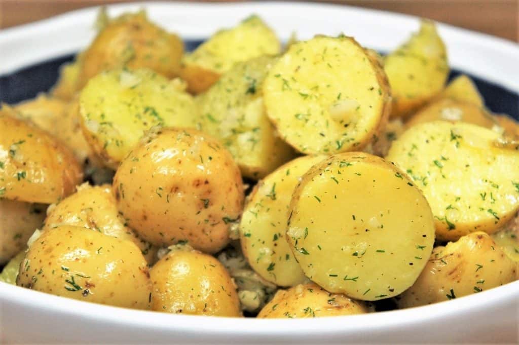 Gold potatoes cut in half and tossed in garlic and dill oil.