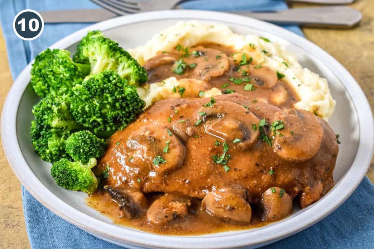 Chicken and mushrooms with brown gravy served with mashed potatoes and broccoli.