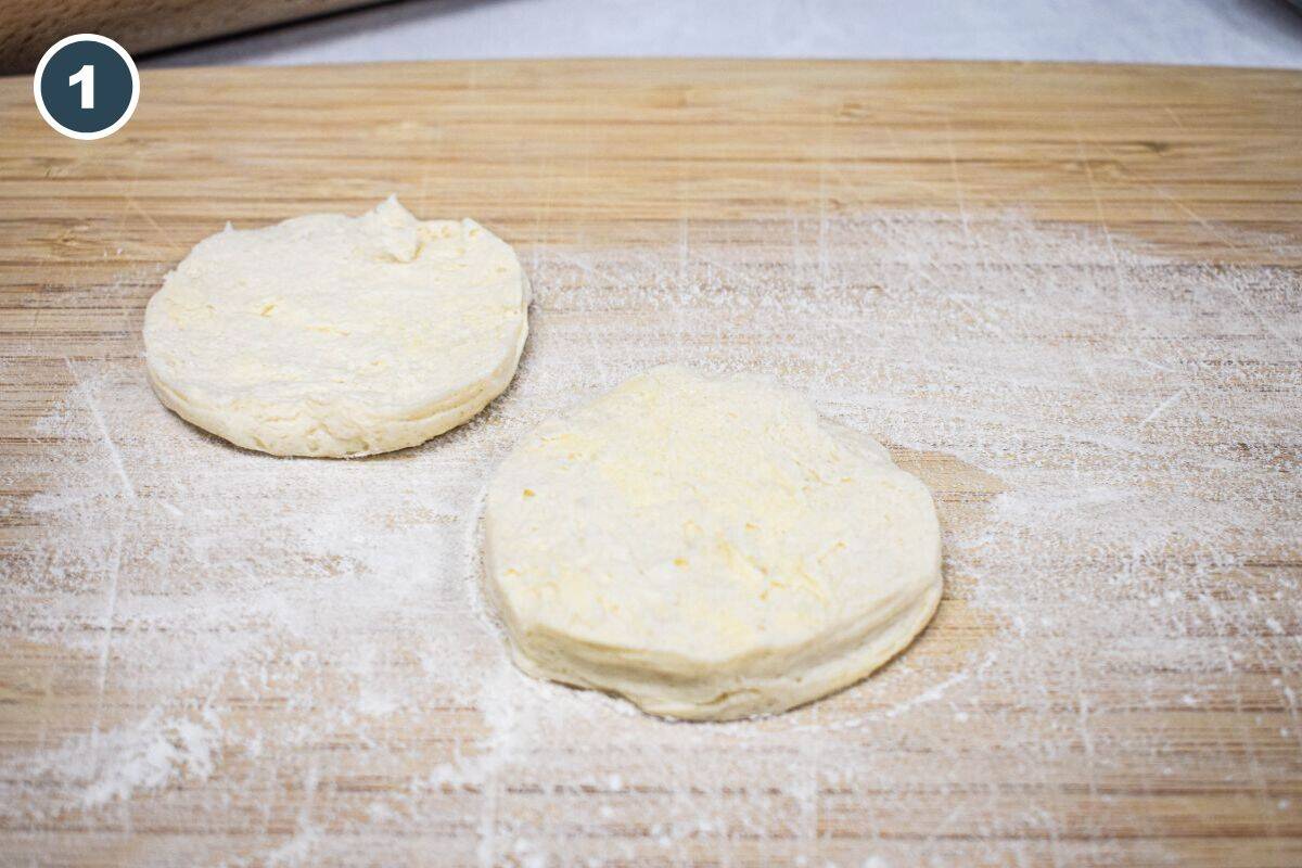 Biscuit dough rounds on a floured board.