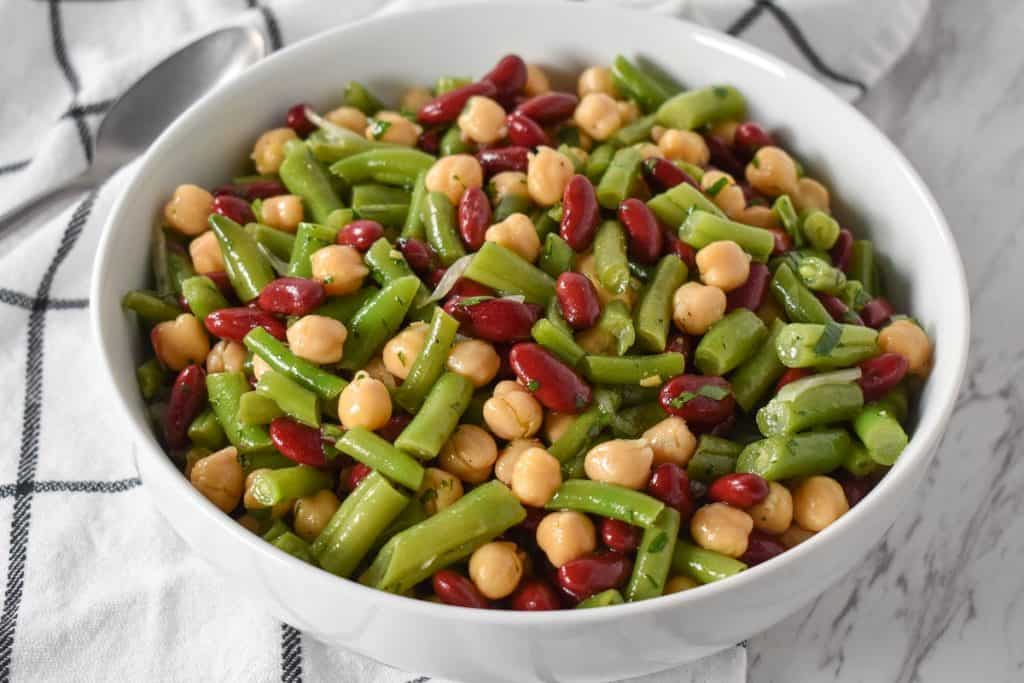 Three Bean Salad served in a large, white platter.