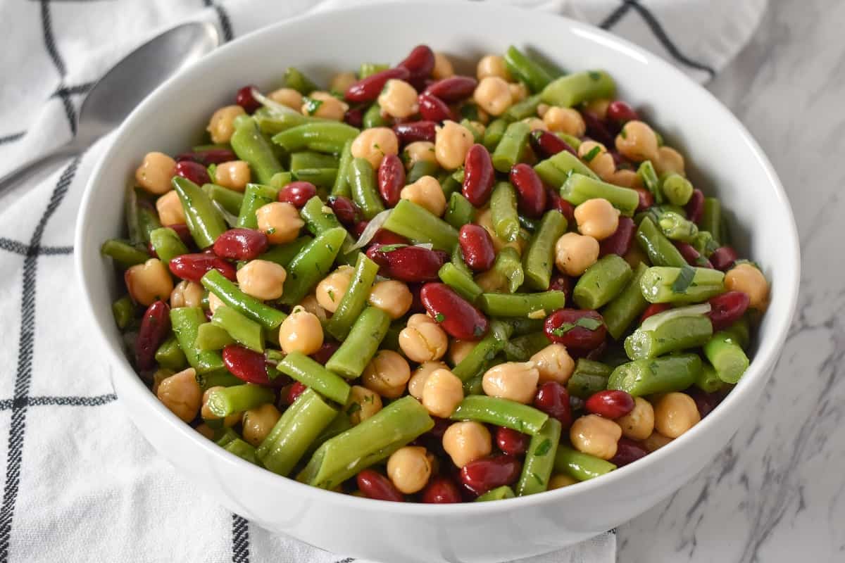 Three Bean Salad served in a large, white platter.