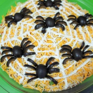 A bean dip with spiders made from black olive pieces.