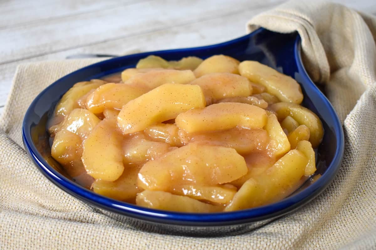 Cinnamon Apples served in a blue stoneware skillet.