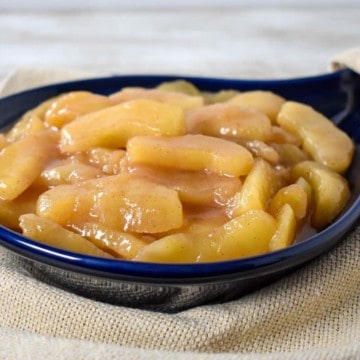 Cinnamon Apples served in a blue stoneware skillet.