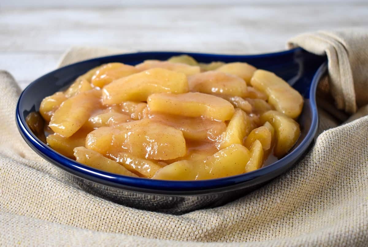 Cinnamon Apples served in a blue stoneware skillet.