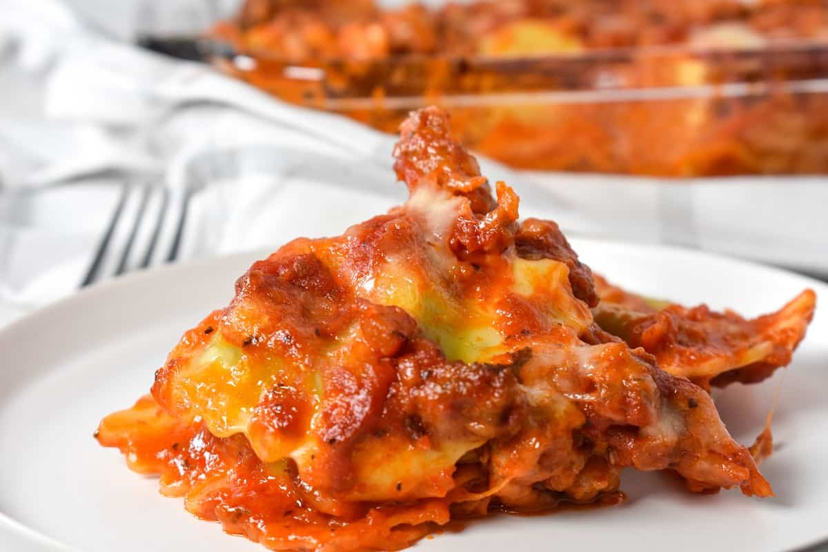 A piece of ravioli bake served on a white plate.