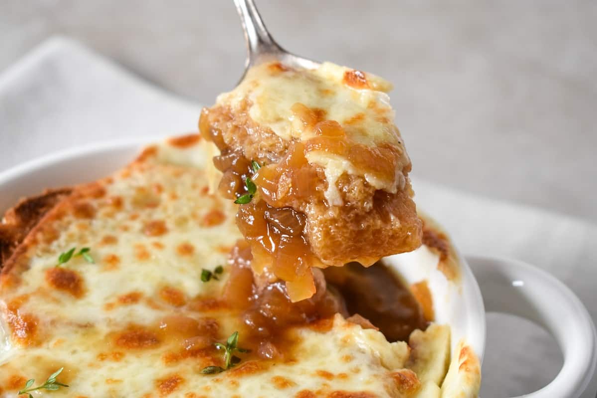 A close-up image of a spoonful of soup held over the bowl.