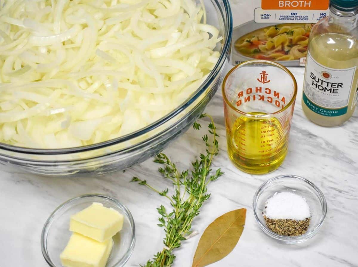 The ingredients for the soup arranged on a white table.