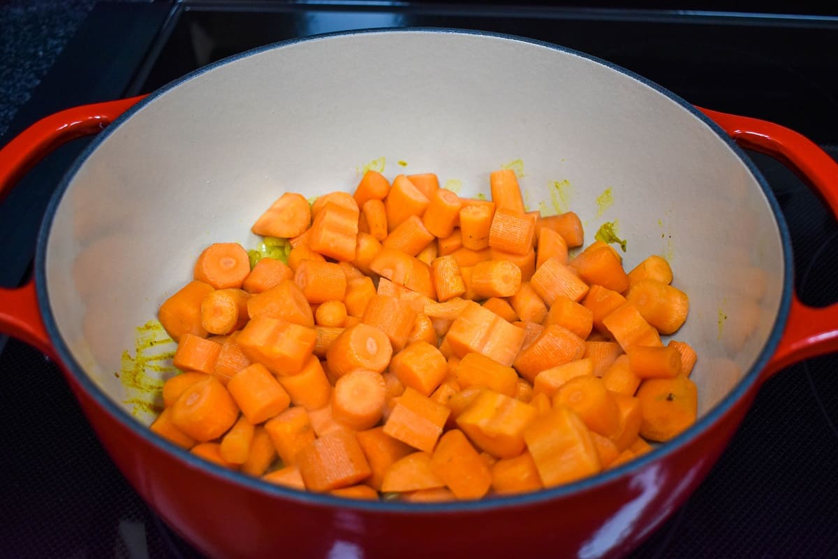 Cut carrots added to the pot covering the ingredients already in there.