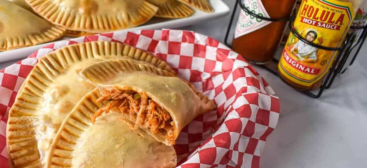 A close up of the chicken empanadas in a lined basket.