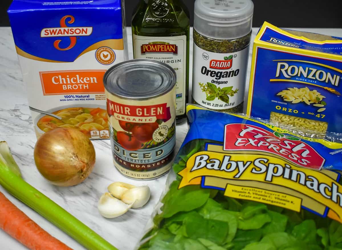 The ingredients for the soup component displayed on a white table.