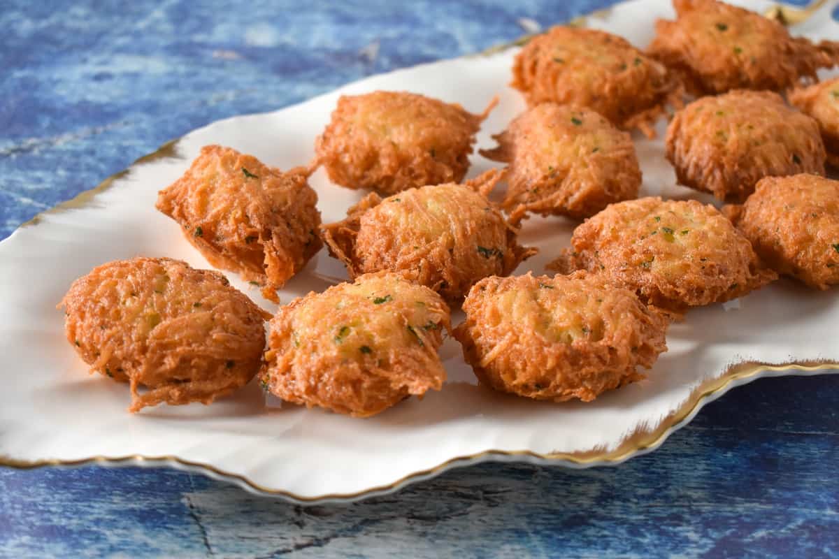 Malanga Fritters displayed on a white platter.