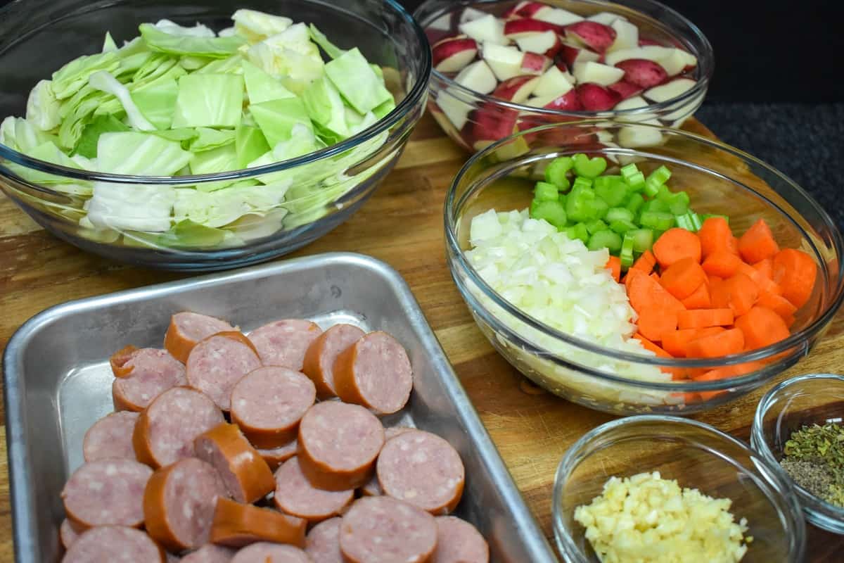 The prepped ingredients for the soup displayed on a wood cutting board.